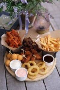 a plateful of fried foods with sauces sitting on a table